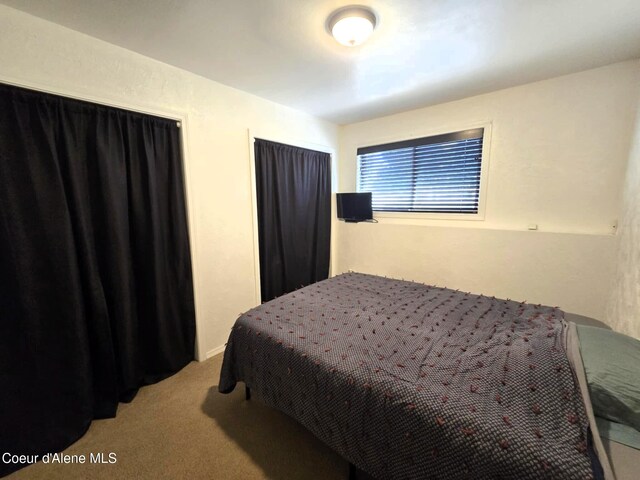 bedroom featuring light carpet