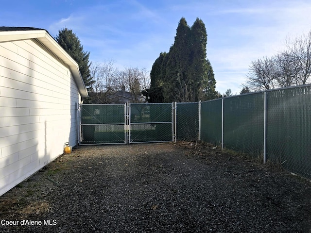 view of gate with fence