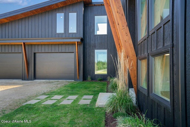 view of property exterior featuring dirt driveway and a yard