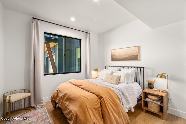 bedroom featuring baseboards, recessed lighting, and wood finished floors
