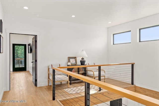 hall with recessed lighting, baseboards, an upstairs landing, and light wood finished floors
