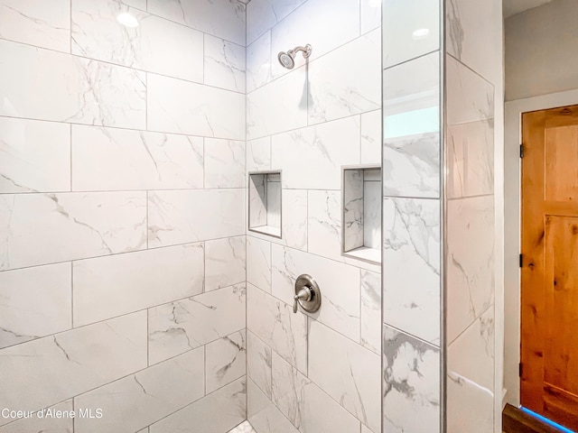 bathroom with a tile shower