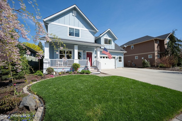 view of front of house featuring board and batten siding, covered porch, a front yard, and concrete driveway
