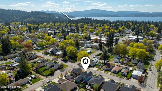 birds eye view of property with a residential view, a view of trees, and a water and mountain view