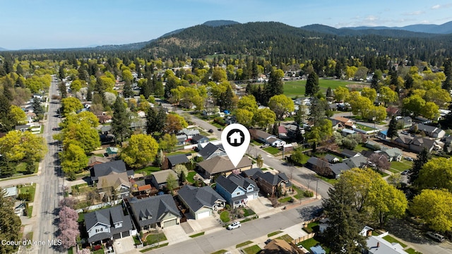 drone / aerial view featuring a mountain view, a residential view, and a forest view