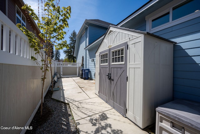 view of shed featuring fence