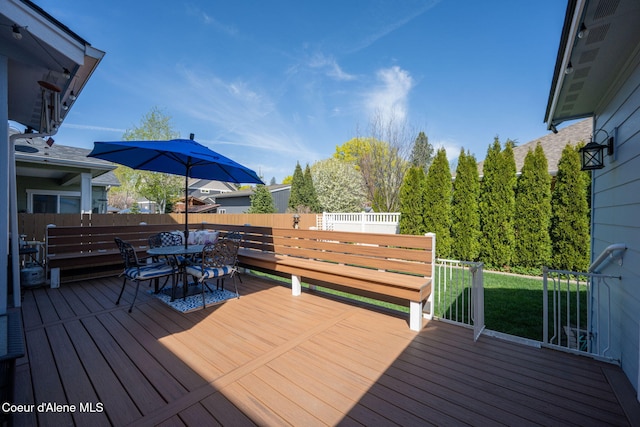 wooden deck with fence and outdoor dining space