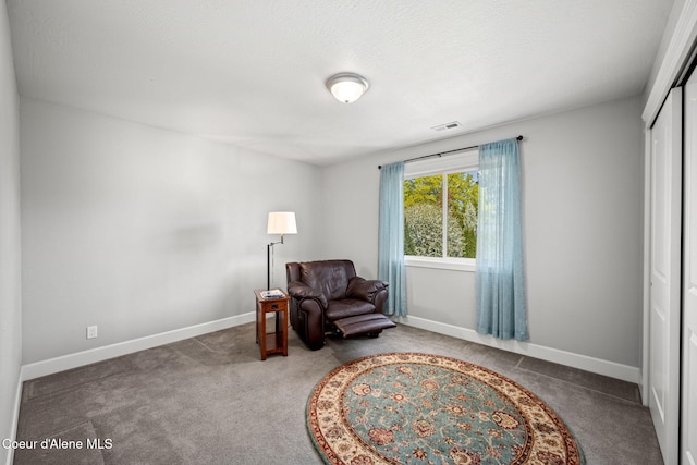 living area with baseboards, carpet, and visible vents