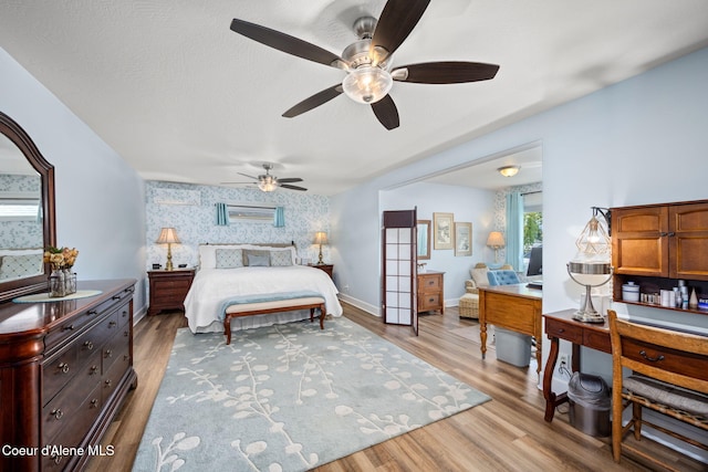 bedroom featuring baseboards, ceiling fan, and light wood-type flooring