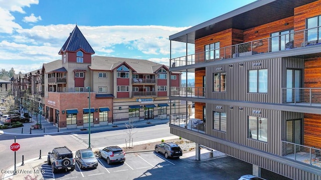 1579 W Riverstone Dr # 306, Coeur Dalene, ID 83814 - view of building exterior with uncovered parking