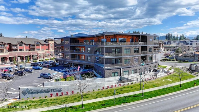 1579 W Riverstone Dr # 306, Coeur Dalene, ID 83814 - view of building exterior featuring uncovered parking