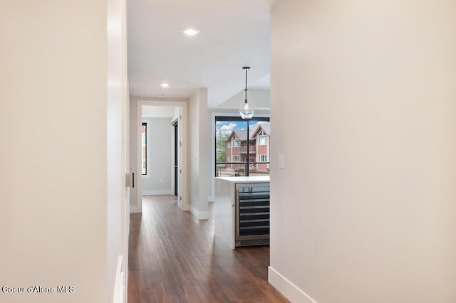 1579 W Riverstone Dr # 306, Coeur Dalene, ID 83814 - hallway with baseboards, dark wood-type flooring, wine cooler, and recessed lighting