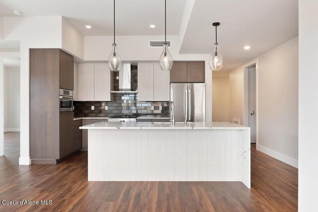 1579 W Riverstone Dr # 306, Coeur Dalene, ID 83814 - kitchen featuring modern cabinets, stainless steel appliances, light countertops, wall chimney exhaust hood, and visible vents