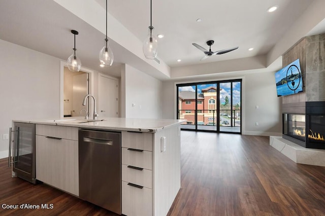 1579 W Riverstone Dr # 306, Coeur Dalene, ID 83814 - kitchen with beverage cooler, stainless steel dishwasher, a sink, modern cabinets, and open floor plan