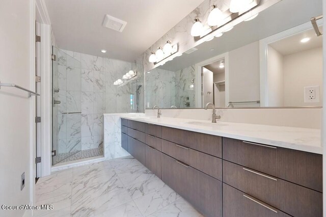 1579 W Riverstone Dr # 306, Coeur Dalene, ID 83814 - bathroom featuring double vanity, marble finish floor, a sink, and a marble finish shower