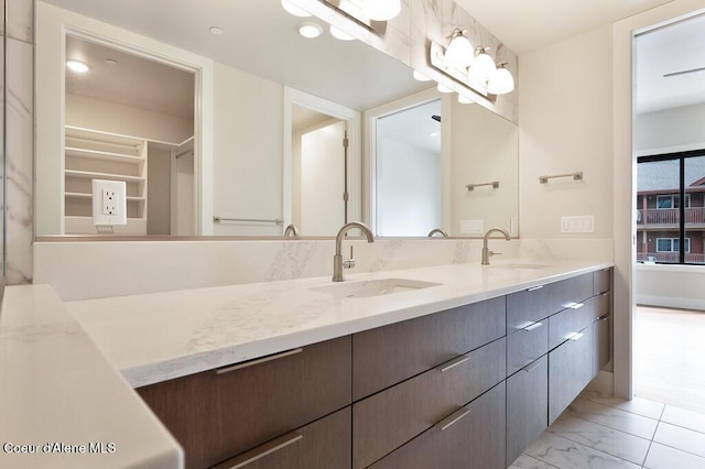 1579 W Riverstone Dr # 306, Coeur Dalene, ID 83814 - full bath with a walk in closet, double vanity, marble finish floor, and a sink