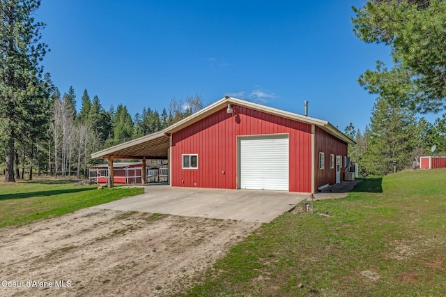 exterior space featuring dirt driveway and a detached garage