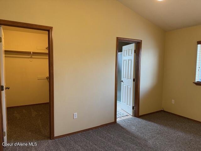 2359 N Alfalfa Loop, Post Falls, ID 83854 - unfurnished bedroom with a walk in closet, vaulted ceiling, carpet floors, and baseboards