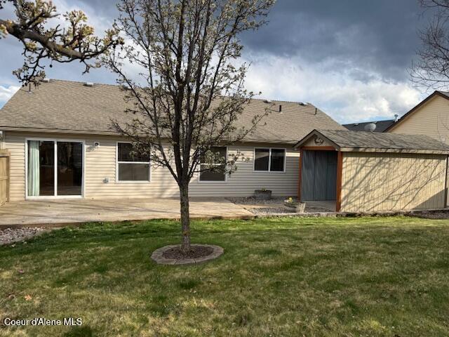 2359 N Alfalfa Loop, Post Falls, ID 83854 - back of property featuring a yard, roof with shingles, and an outbuilding