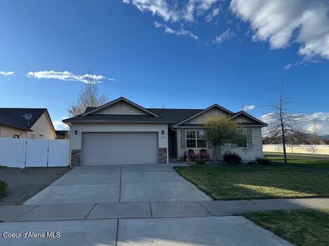 2359 N Alfalfa Loop, Post Falls, ID 83854 - ranch-style home with a gate, driveway, fence, a garage, and a front yard