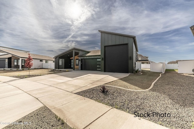 11506 N Clapton Ln, Rathdrum, ID 83858 - view of outdoor structure featuring concrete driveway, fence, and a garage
