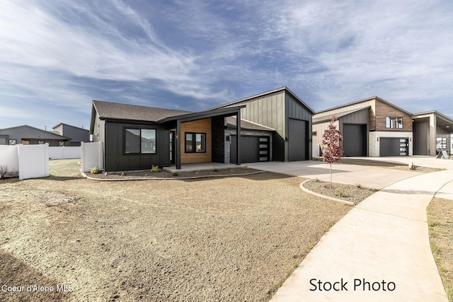 11506 N Clapton Ln, Rathdrum, ID 83858 - mid-century home featuring driveway, a garage, fence, and board and batten siding