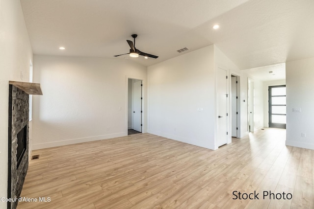 11506 N Clapton Ln, Rathdrum, ID 83858 - unfurnished living room featuring ceiling fan, a stone fireplace, light wood-style floors, baseboards, and recessed lighting