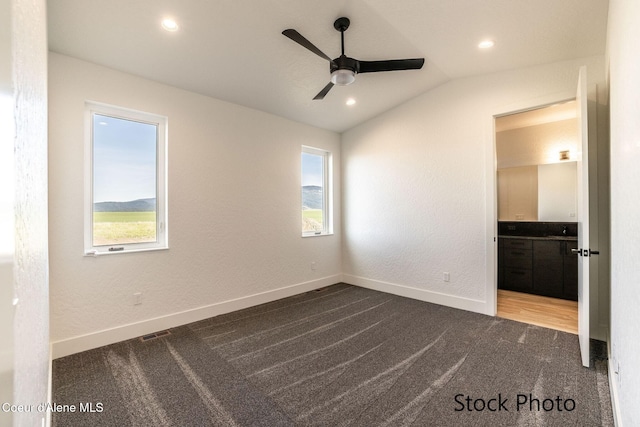 11506 N Clapton Ln, Rathdrum, ID 83858 - unfurnished bedroom featuring carpet flooring, multiple windows, lofted ceiling, baseboards, and recessed lighting