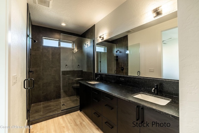 11506 N Clapton Ln, Rathdrum, ID 83858 - full bath with a stall shower, wood finished floors, a textured ceiling, and double vanity