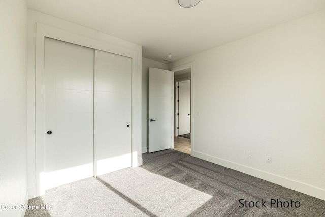 11506 N Clapton Ln, Rathdrum, ID 83858 - unfurnished bedroom featuring dark colored carpet, baseboards, and a closet