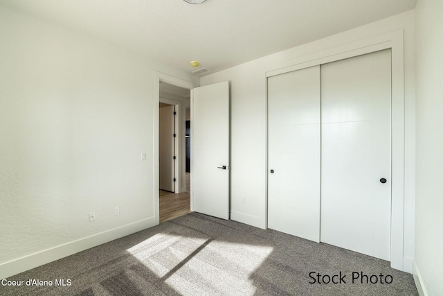 11506 N Clapton Ln, Rathdrum, ID 83858 - unfurnished bedroom featuring carpet flooring, baseboards, and a closet