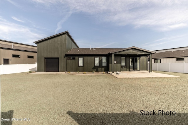 11506 N Clapton Ln, Rathdrum, ID 83858 - rear view of property with a fenced backyard, a patio area, and a garage