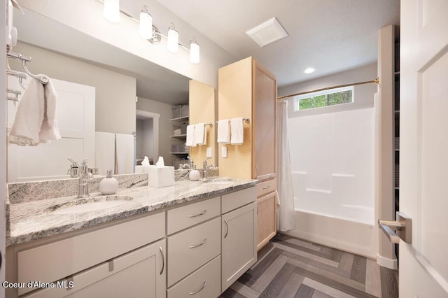 full bathroom with a sink, shower / tub combo with curtain, and double vanity
