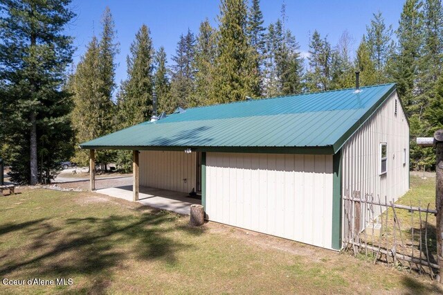 exterior space with a carport and fence