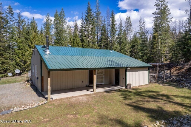 exterior space featuring a carport and a forest view
