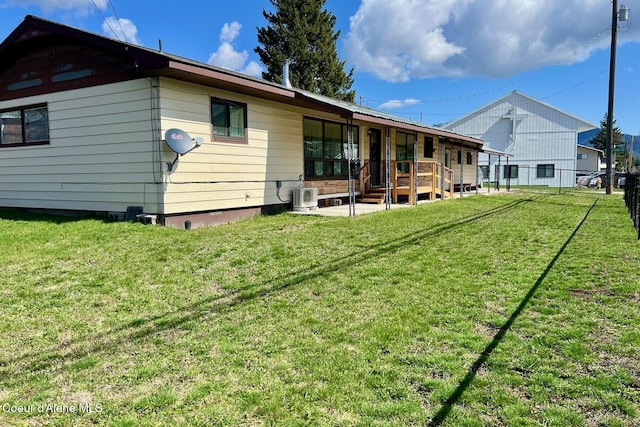 321 High St, Priest River, ID 83856 - rear view of house featuring a yard, ac unit, and fence