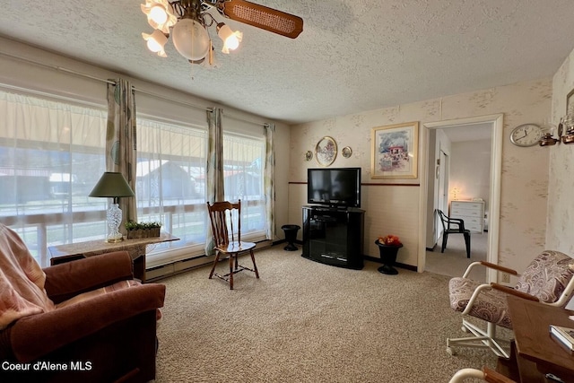 321 High St, Priest River, ID 83856 - living room with a textured ceiling, light colored carpet, wallpapered walls, baseboard heating, and ceiling fan