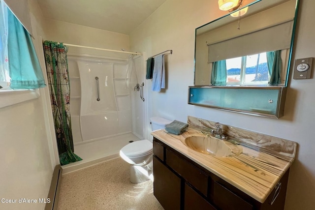 321 High St, Priest River, ID 83856 - bathroom with a shower stall, toilet, vanity, and baseboard heating