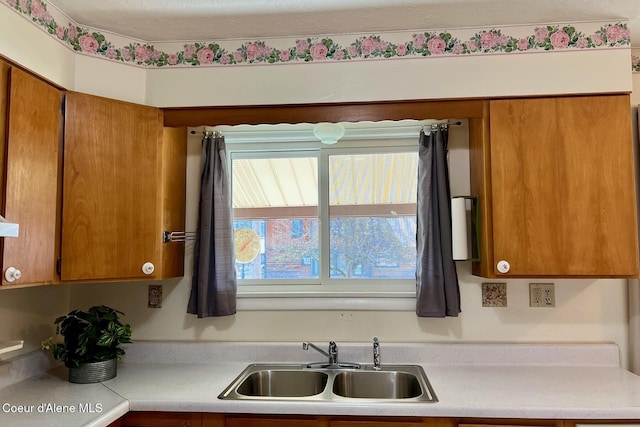321 High St, Priest River, ID 83856 - kitchen featuring brown cabinets, a sink, and light countertops