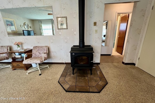 321 High St, Priest River, ID 83856 - carpeted living room featuring a wood stove and wallpapered walls