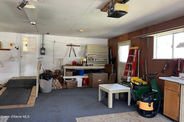 321 High St, Priest River, ID 83856 - garage with wood walls, a workshop area, and a garage door opener