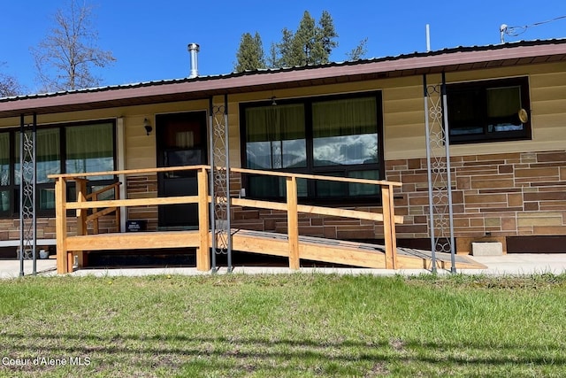 321 High St, Priest River, ID 83856 - view of exterior entry with a yard and metal roof