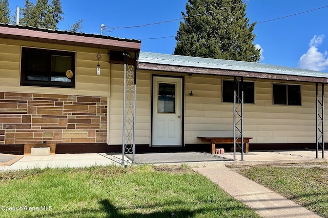 321 High St, Priest River, ID 83856 - entrance to property with a yard and metal roof