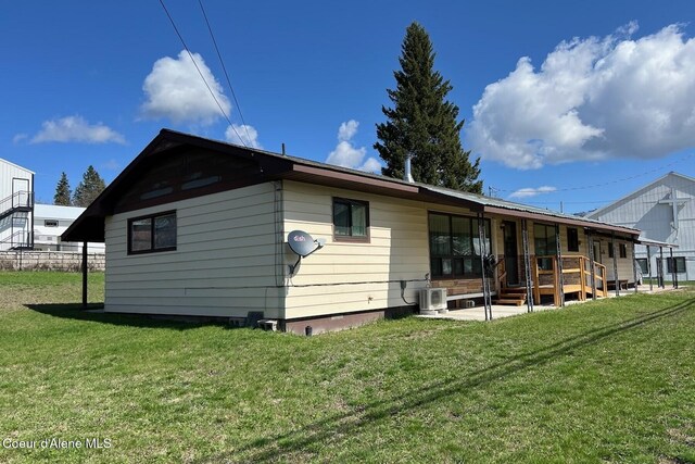 321 High St, Priest River, ID 83856 - rear view of property with a porch, a yard, and cooling unit