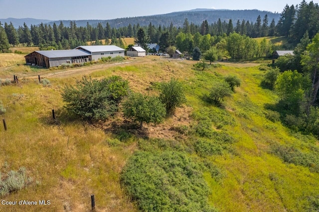birds eye view of property featuring a wooded view