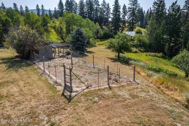 view of yard with fence and an outdoor structure