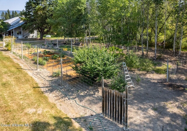 view of yard with fence and a vegetable garden