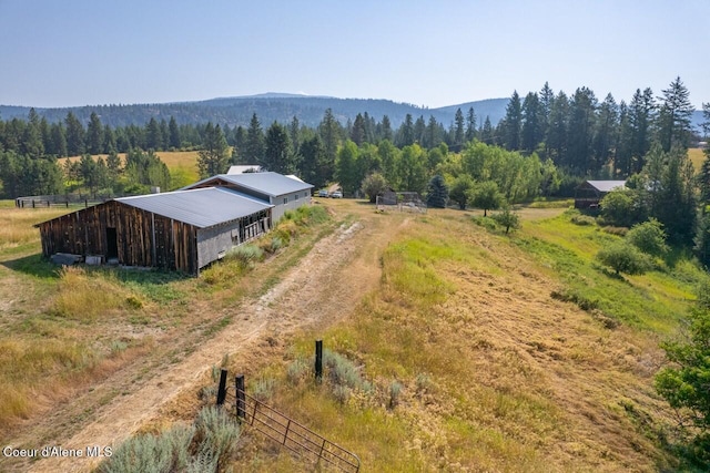 birds eye view of property with a forest view and a rural view