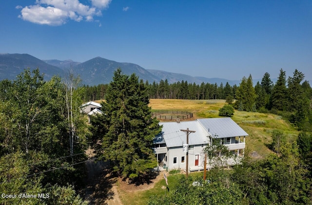 birds eye view of property with a view of trees and a mountain view