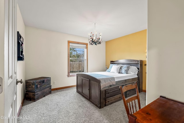 carpeted bedroom featuring a chandelier and baseboards